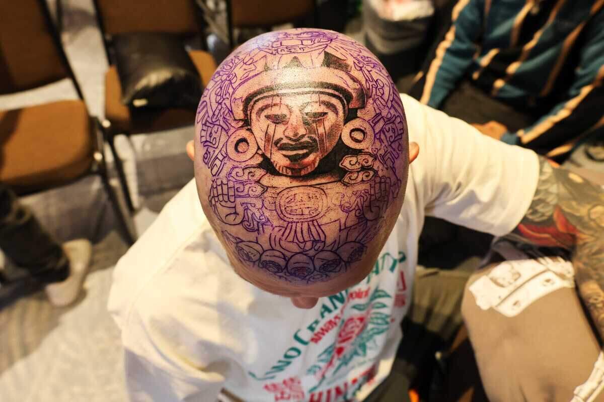 Nick Struyf shows the progress of his head tattoo at the Capitol City Classic tattoo convention in Sacramento, California, on Saturday, June 12, 2026.