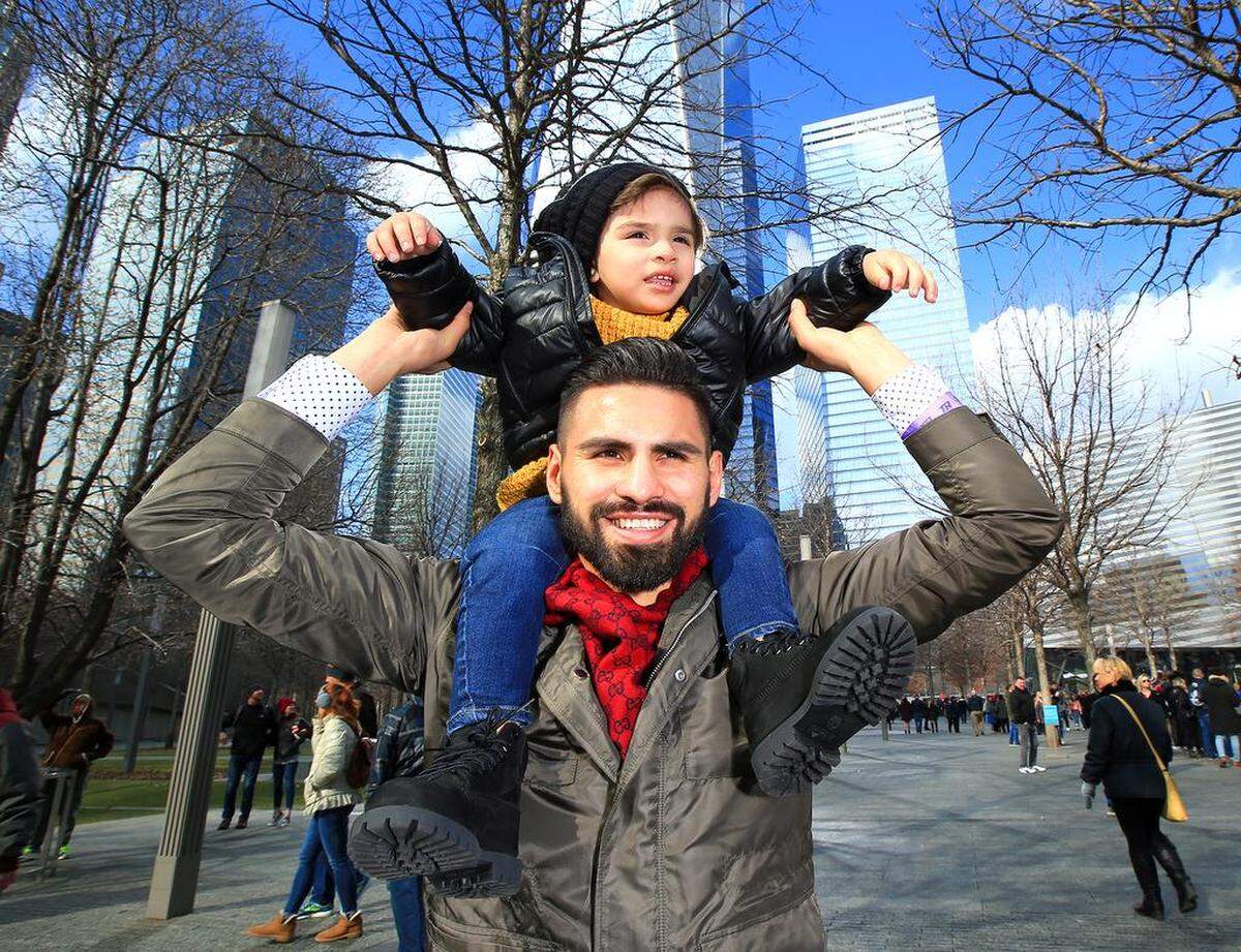 Jose Ramirez holds his son, Matteo, over his shoulders in New York.