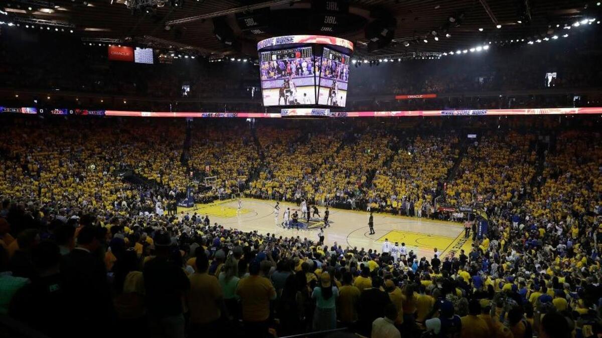Fans at Oracle Arena watch the opening tipoff of Game 2 of basketball's NBA Finals between the Golden State Warriors and the Cleveland Cavaliers in Oakland, Calif., Sunday, June 4, 2017.