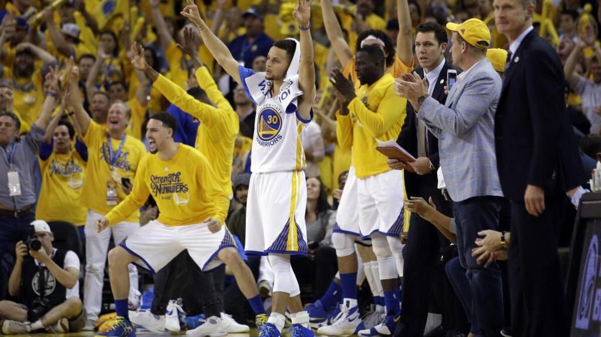 Golden State Warriors' Stephen Curry (30) and teammates on the bench celebrate after a three-pointer during the second half on Thursday, May 26, 2016, in Oakland.