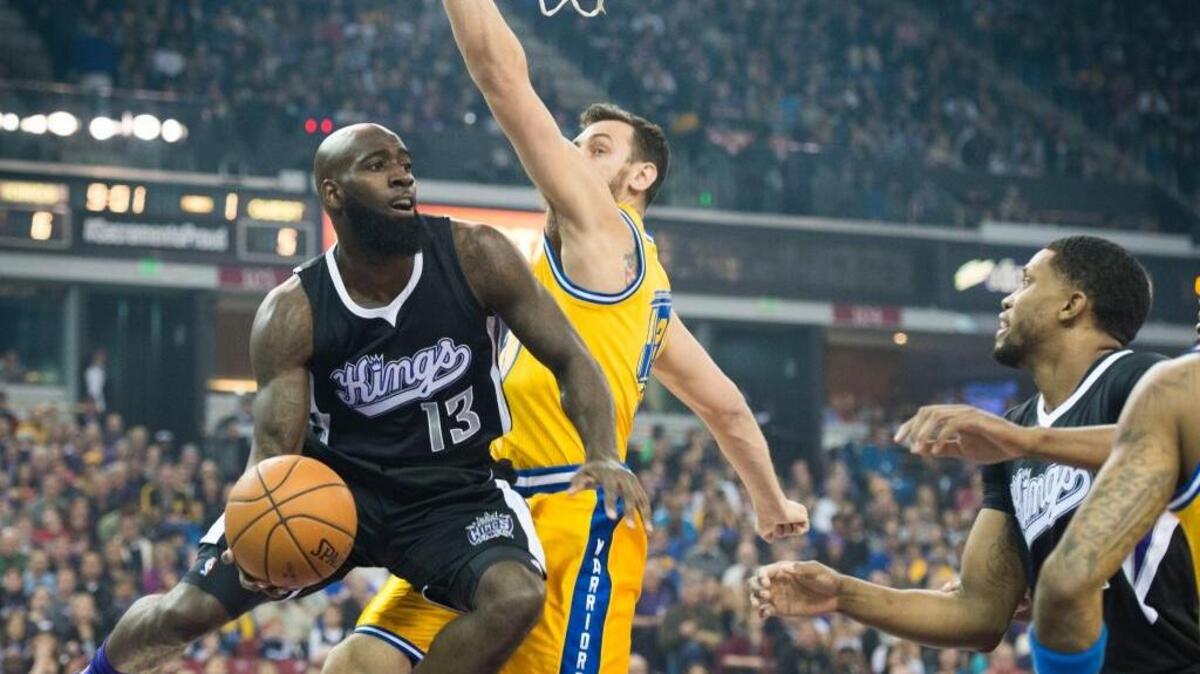 Sacramento Kings forward Quincy Acy (13) looks to pass the ball as he’s defended by Golden State Warriors center Andrew Bogut (12) during an NBA basketball game Saturday, Jan. 9, 2016 at Sleep Train Arena in Sacramento.