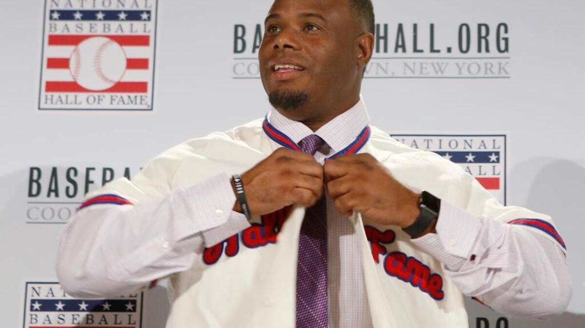 Ken Griffey Jr. buttons up his Hall of Fame jersey after he and Mike Piazza were announced as electees into the 2016 Baseball Hall of Fame class, Thursday, Jan. 7, 2016, in New York. Griffey was elected to with the highest voting percentage ever.