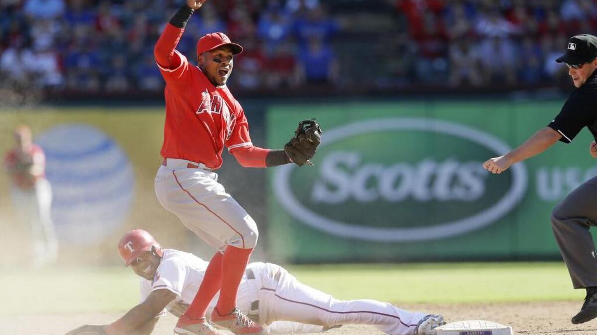 
Shortstop Erick Aybar celebrates after tagging out Elvis Andrus of the Rangers for the final out of the game in an 11-10 Angels win on Saturday, Oct. 3, 2015 in Arlington, Texas. Andrus appeared to have stolen second base, but his slide carried him past the bag and was tagged out. 

