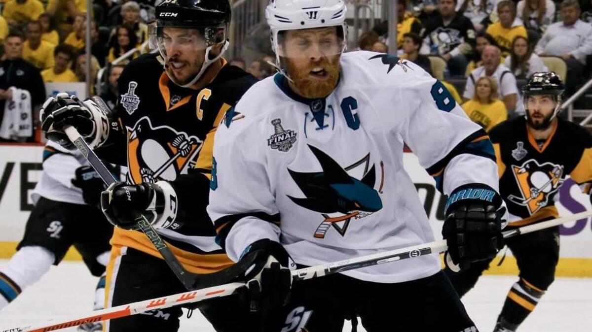 Pittsburgh Penguins captain Sidney Crosby, left, skates with San Jose Sharks captain Joe Pavelski during the second period in Game 2 of the NHL hockey Stanley Cup Final on Wednesday, June 1, 2016, in Pittsburgh. Crosby won the face-off in overtime that led to the game-winning goal. Crosby got an assist on the score.