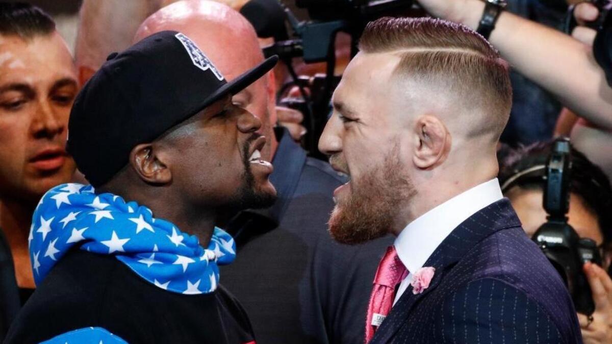 Floyd Mayweather Jr., left, and Conor McGregor exchange words during a news conference at Staples Center on July 11 in Los Angeles. The two will fight in a boxing match in Las Vegas on Aug. 26.