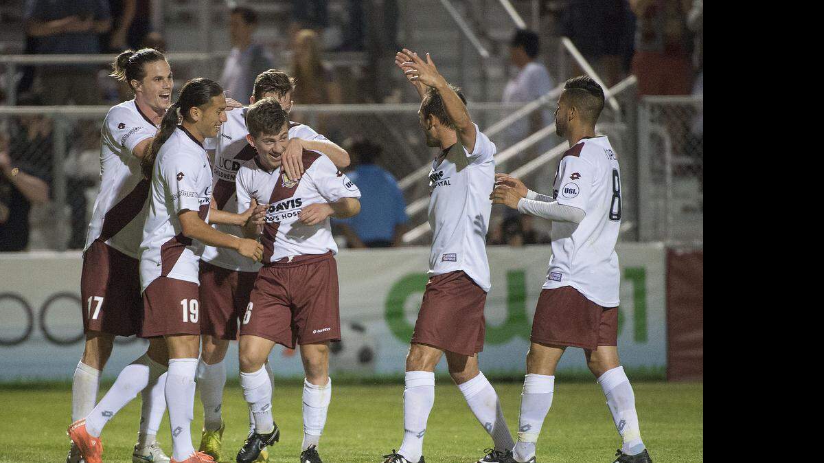 
Republic FC midfielder Zev Taublieb (16), center, is congratulated by teammates after he scored the team's third and final goal during the game between the Sacramento Republic FC and the Portland Timbers II at Bonney Field in Sacramento on Saturday, April 18, 2015. Sacramento won the match 3-0.
