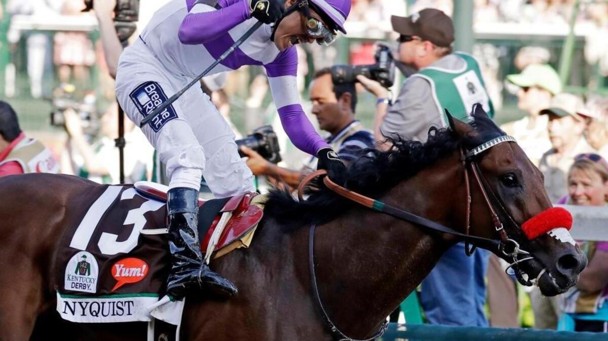 Mario Gutierrez celebrates after riding Nyquist to victory during the 142nd running of the Kentucky Derby horse race at Churchill Downs Saturday, May 7, 2016, in Louisville, Ky. On a sloppy track, Guiterrez and Nyquist came through cleanly, avoiding the mud that spattered the field.