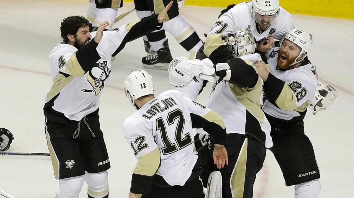 The Penguins celebrate around goaltender Matt Murray, center, after beating the Sharks 3-1 in Game 6 of the Stanley Cup Final at SAP Center.