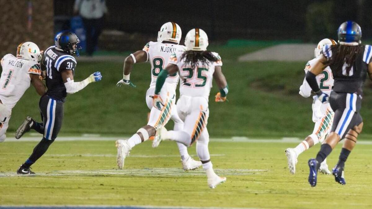 Miami’s Corn Elder (29) returns a kickoff, which featured multiple laterals before Elder subsequently received the final lateral, and scores to beat Duke 30-27 in an NCAA college football game, in Durham, N.C., Saturday, Oct. 31, 2015. Miami’s Mark Walton (1) was called for a block in the back on Duke’s Breon Borders (31), at the far left of this image, but the penalty was taken back. The Atlantic Coast Conference has suspended the officiating crew for two games because of mistakes made on the play.
