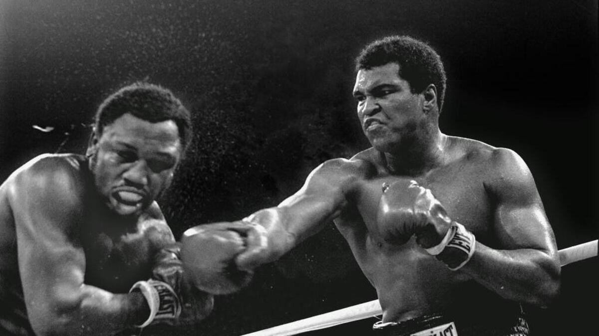 In this Oct. 1, 1975 file photo, Heavyweight champion Muhammad Ali connects with a right against challenger Joe Frazier in the ninth round of their title fight in Manila, Philippines. Ali won the fight on a decision to retain the title. Ali, the magnificent heavyweight champion whose fast fists and irrepressible personality transcended sports and captivated the world, has died according to a statement released by his family Friday, June 3, 2016. He was 74.