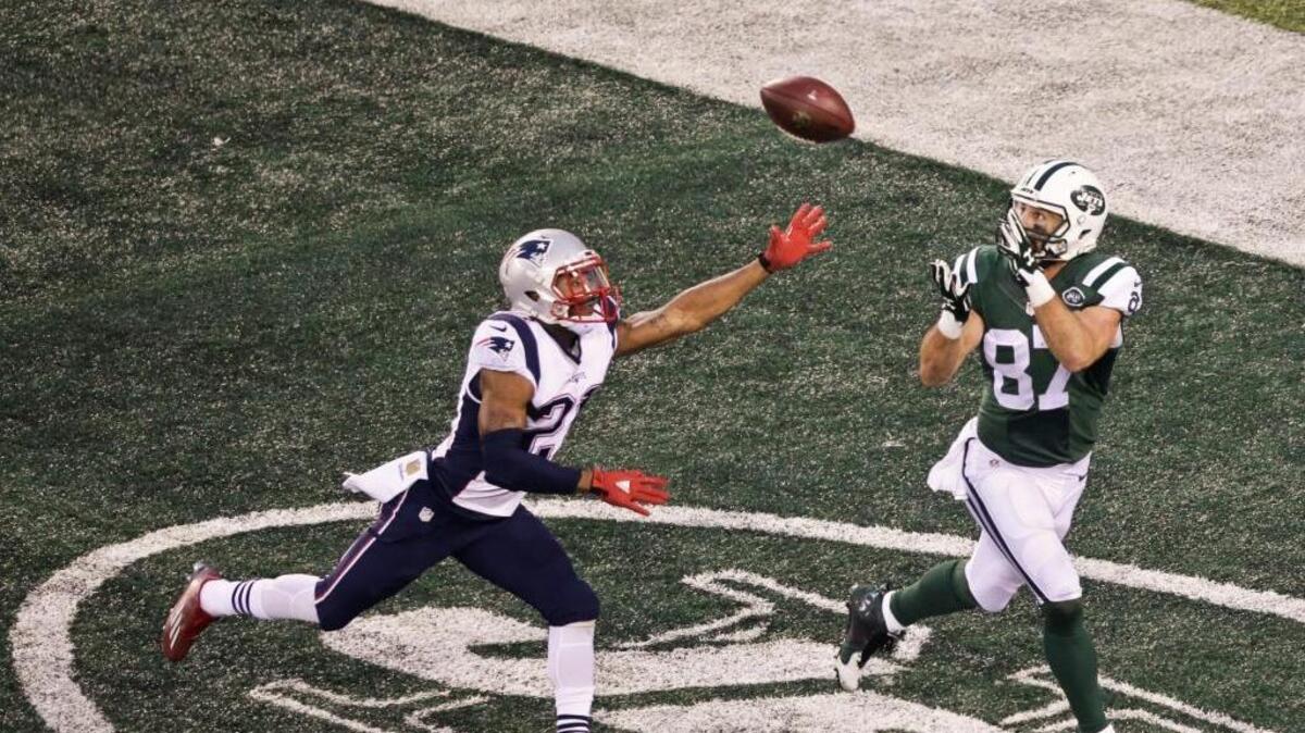 New York Jets wide receiver Eric Decker (87) catches a pass for a touchdown in front of New England Patriots’ Malcolm Butler (21) in overtime during an NFL football game Sunday, Dec. 27, 2015, in East Rutherford, N.J. The Jets won 26-20 after the Patriots won the coin toss and elected to kick to begin overtime.