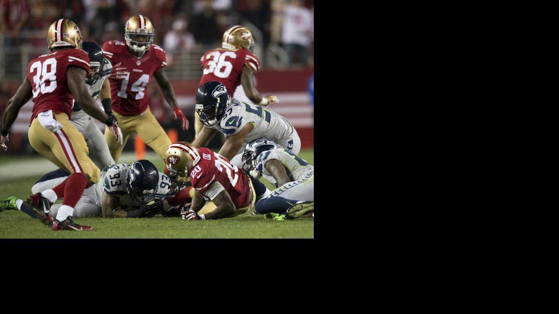 
San Francisco 49ers cornerback Perrish Cox (20) fumbles punt return and ball is recovered by Seattle Seahawks defensive end O'Brien Schofield (93) in the second quarter.
