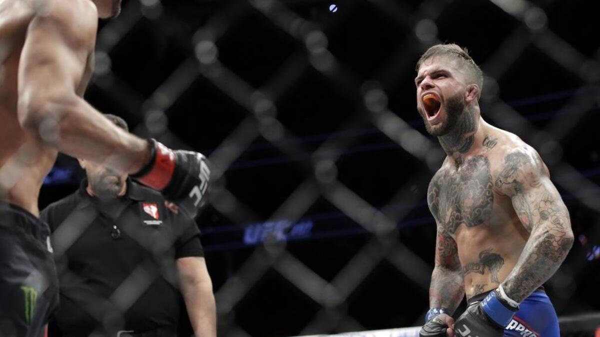 Cody Garbrandt, right, yells at Dominick Cruz during a bantamweight championship mixed martial arts bout at UFC 207, Friday, Dec. 30, 2016, in Las Vegas.