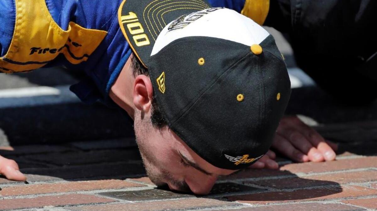 Alexander Rossi kisses the bricks on the start/finish line after wining the 100th running of the Indianapolis 500 auto race at Indianapolis Motor Speedway in Indianapolis on Sunday, May 29, 2016. The rookie driver is a Nevada City native.