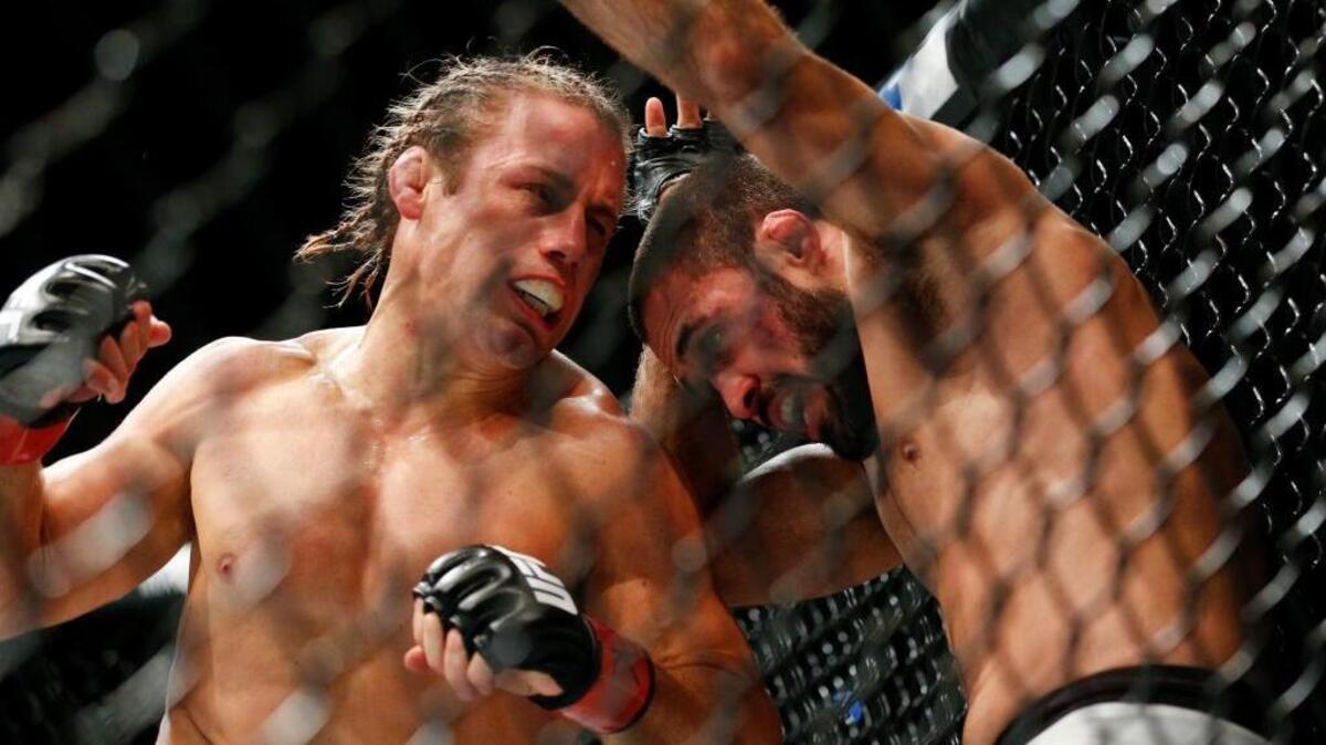Urijah Faber, left, fights Frankie Saenz during a bantamweight mixed martial arts bout at UFC 194, Saturday, Dec. 12, 2015, in Las Vegas.