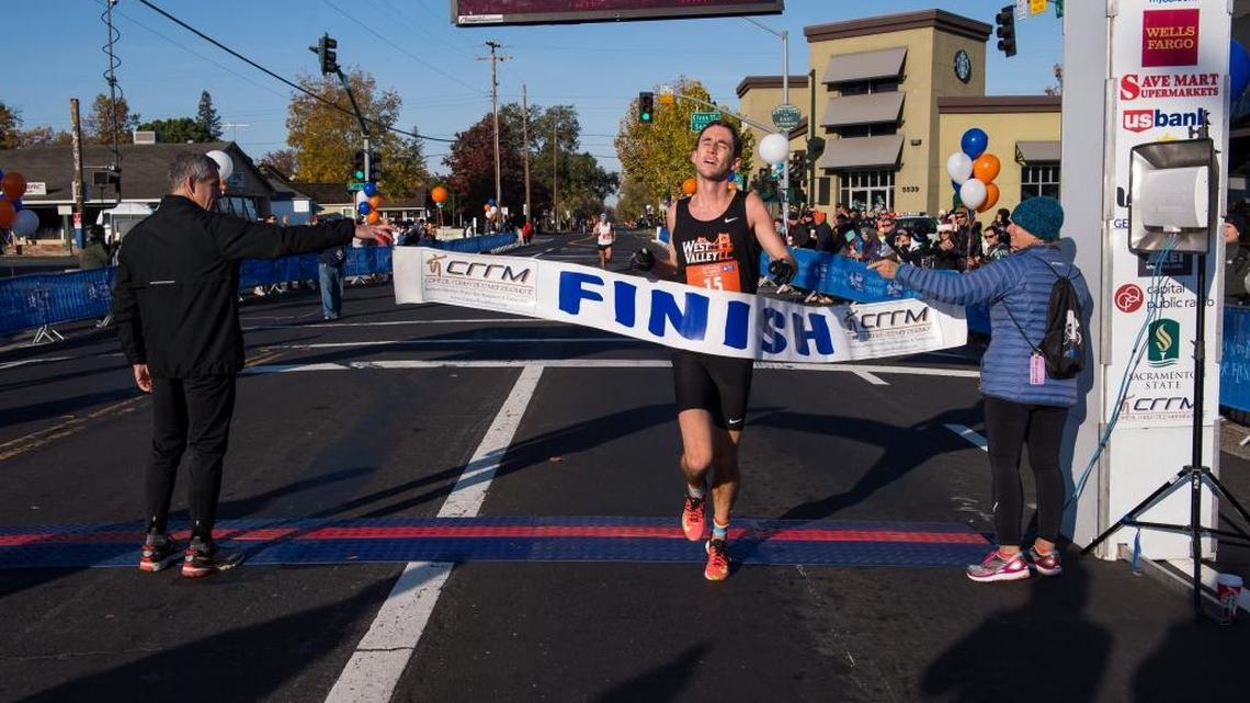 Nicholas Spector crosses the finish line to win the Run to Feed the Hungry 10K in Sacramento, Thursday Nov 24, 2016. photo by Brian Baer