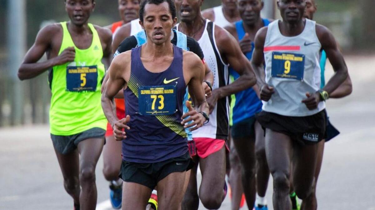 Birhanu Dare #73 led the pack early on during the 32nd annual California International Marathon Dec. 7, 2014, that started in Folsom, Calif., and ended at the state Capitol. At right is winner Jacob Chemtai #9.