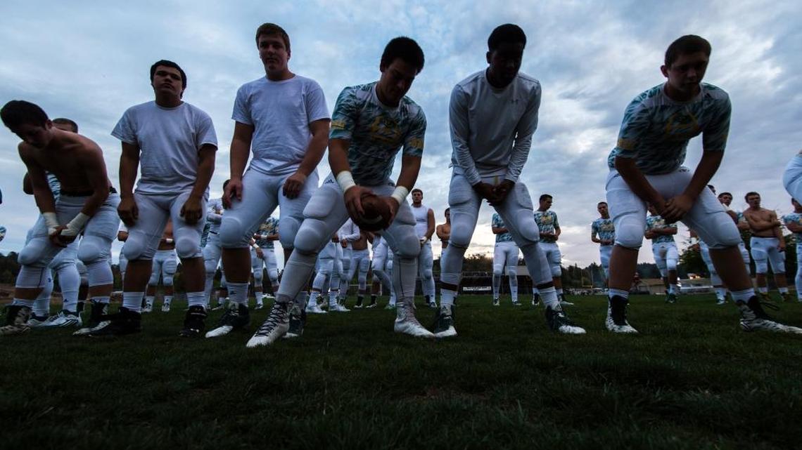 Members of the Placer High School football team warm up before their game against Bear River on Friday October 23, 2015 in Grass Valley.