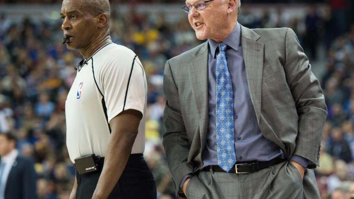 Sacramento Kings coach George Karl, despite reports, is not fired, and guides his team to a nail-biting win over the Philadelphia 76ers before the All-Star break. ... Karl speaks with referee Derrick Collins (11) during an NBA basketball game against the Golden State Warriors on Saturday, Jan. 9, 2016 at Sleep Train Arena in Sacramento.