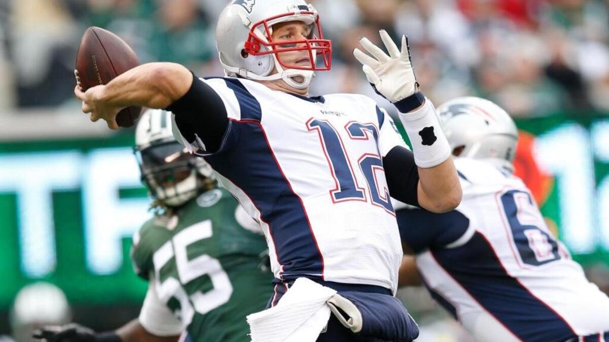 New England Patriots quarterback Tom Brady (12) throws a pass during an NFL football game against the New York Jets on Sunday, Dec. 27, 2015, in East Rutherford, N.J. Brady threw for 231 yards and a touchdown in the 26-20 overtime loss.