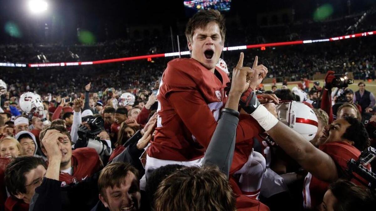 Stanford’s Conrad Ukropina (34) is lifted by fans and teammates after kicking a 45-yard field goal as time expired to give Stanford a 38-36 win over Notre Dame in an NCAA college football game Saturday, Nov. 28, 2015, in Stanford.