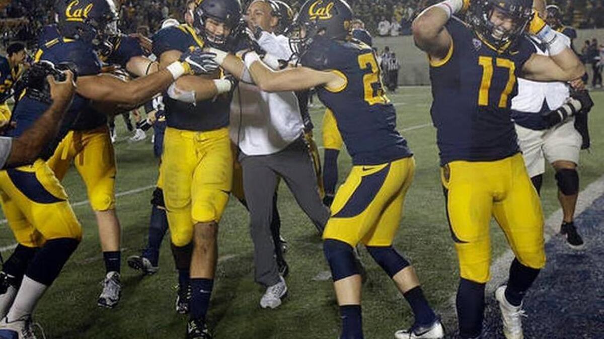 California linebacker Jordan Kunaszyk, second from left, is congratulated after intercepting a pass in the second overtime of an NCAA college football game against Oregon in Berkeley, Calif., Saturday, Oct. 22, 2016. California won 52-49.