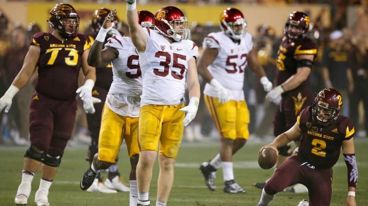 USC linebacker Cameron Smith (35) celebrates his sack of Arizona State’s Mike Bercovici (2) on Sept. 26, 2015, in Tempe, Ariz.