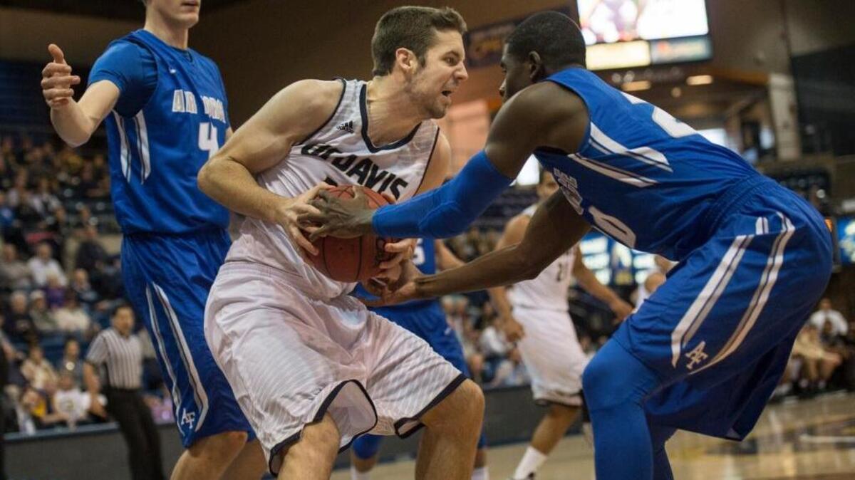 UC Davis center Neal Monson, left, fights for the ball against an Air Force defender on Dec. 19, 2015, at The Pavilion in Davis. The junior is the Big West’s No. 2 rebounder at 8.8 boards per game.