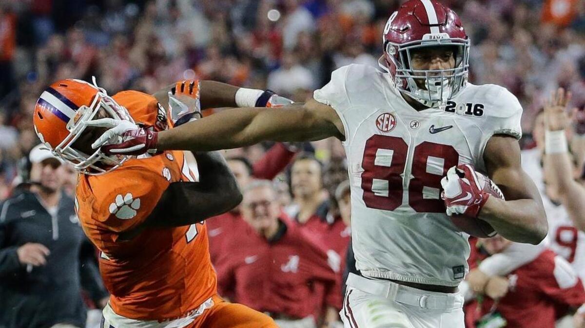 Alabama’s O.J. Howard tries to get past Clemson’s T.J. Green after a catch during the second half of the NCAA college football playoff championship game Monday, Jan. 11, 2016, in Glendale, Ariz. Howard had five catches for 208 yards and two touchdowns.