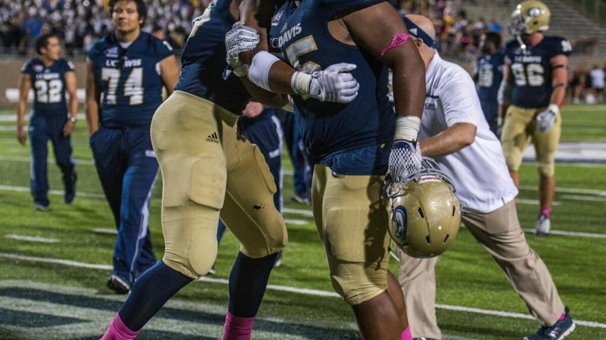 UC Davis defensive lineman Inoke Raikadroka (75) celebrates with defensive lineman Ryan Lefotu after the Aggies’ victory over Northern Arizona last month at Aggie Stadium in Davis.
