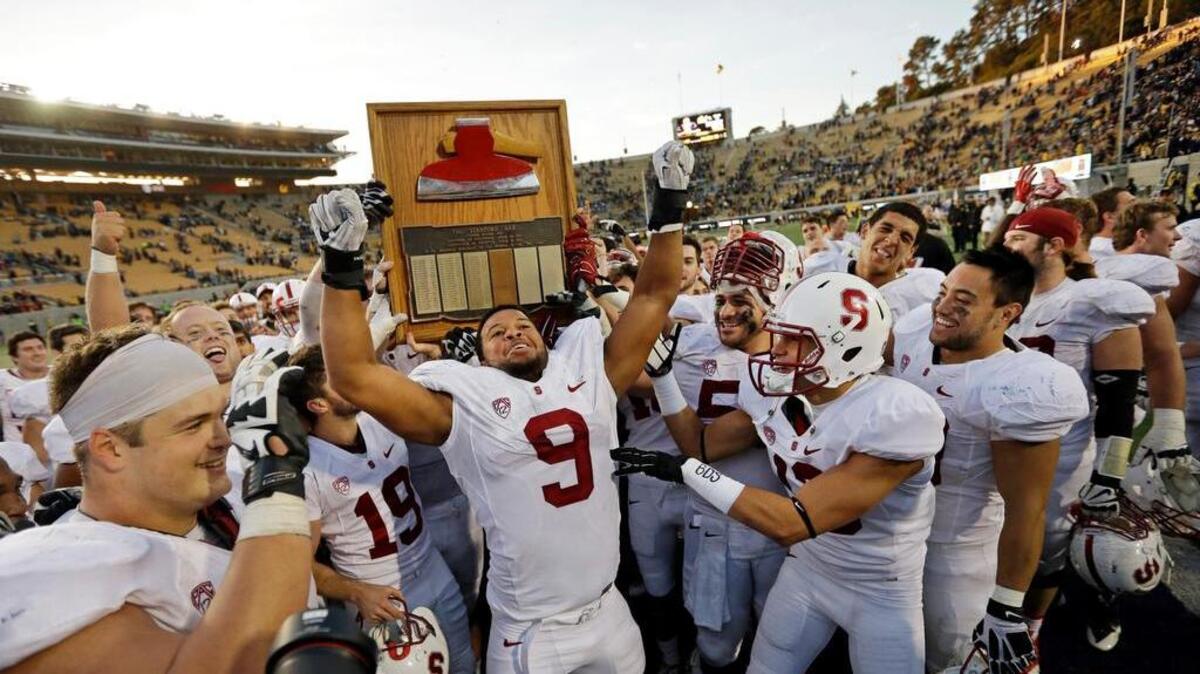 Stanford players, including James Vaughters (9), run with the Stanford Axe after defeating Cal last year in Berkeley.