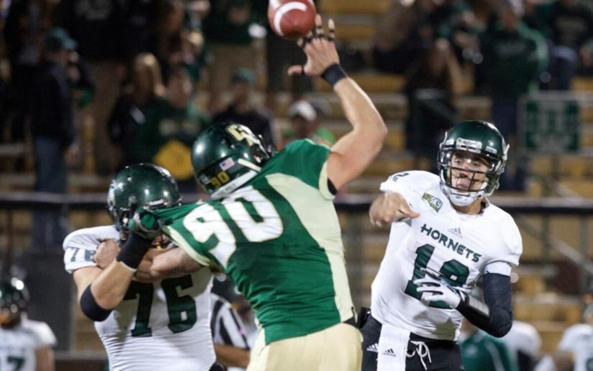 Sacramento's Lars Hanson (76) prevents Cal Poly's Jake Irwin (90) from blocking Hornets QB Garret Safron's (12) pass during first quarter play on Nov. 9, 2013.