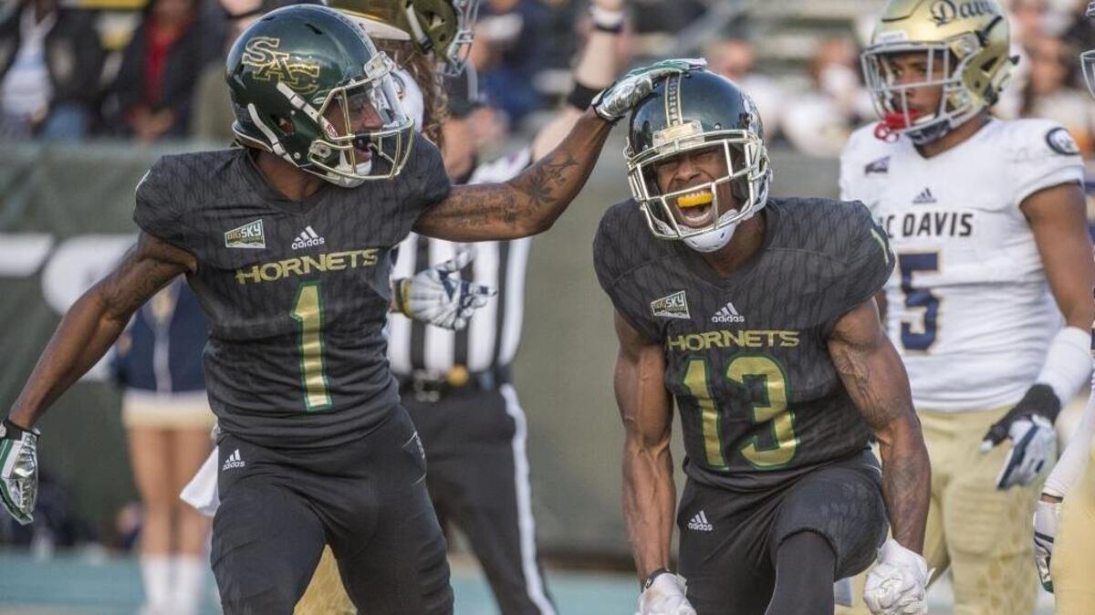 Sacramento State receivers Jaelin Ratliff (13) and Isiah Hennie celebrate Ratliff’s touchdown Saturday during the Causeway Classic. Sacramento State beat UC Davis 52-47.