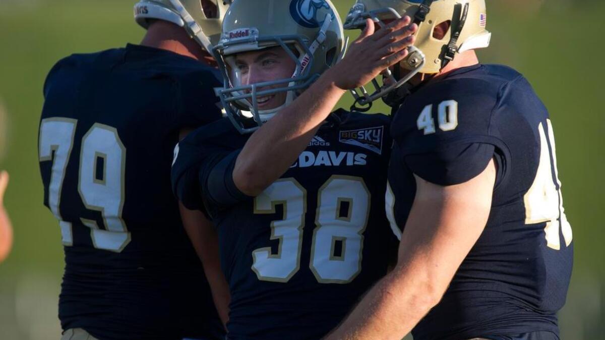
UC Davis’ Brady Stuart, center, celebrates a field goal in 2012.
