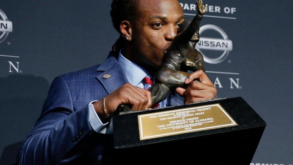 Alabama running back Derrick Henry kisses the Heisman Trophy after winning the award as the country’s top college football player Saturday, Dec. 12, 2015, in New York.
