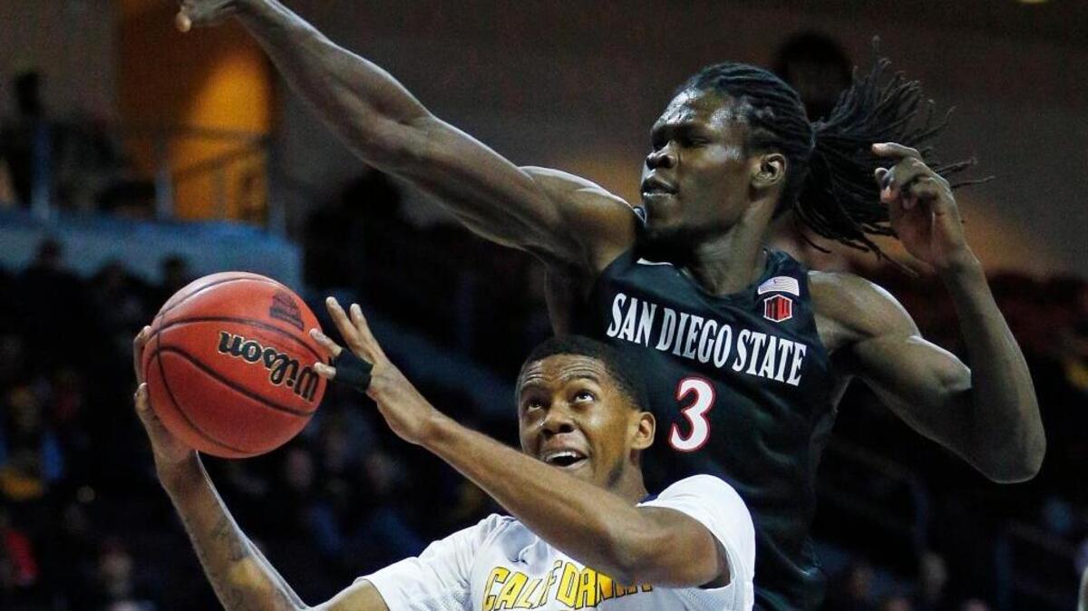 Cal guard Tyrone Wallace tries to shoot around San Diego State forward Angelo Chol during an NCAA college basketball game Thursday, Nov. 26, 2015, in Las Vegas.