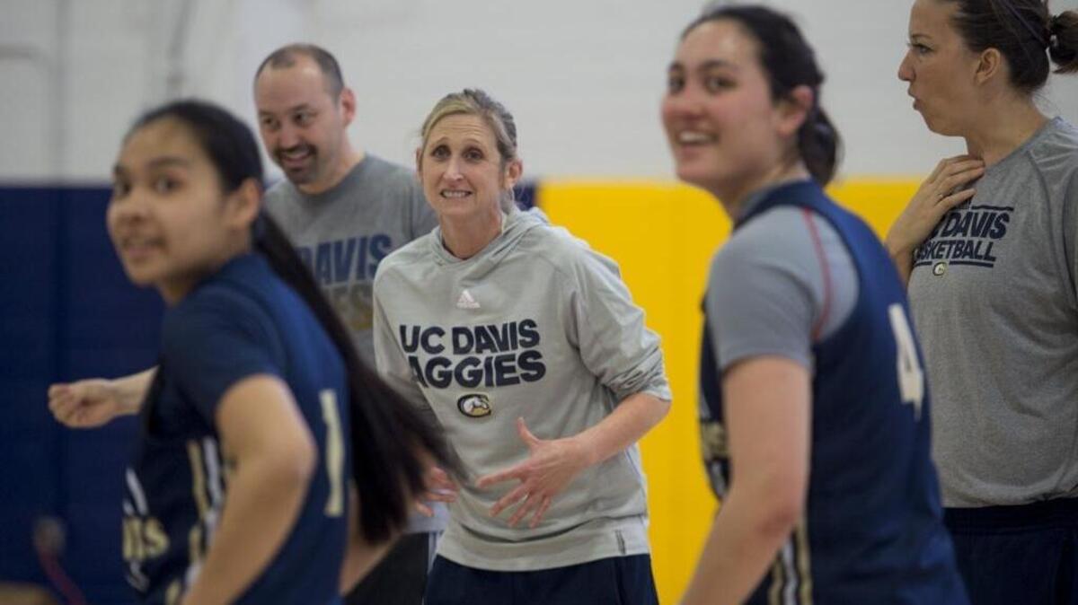 UC Davis Aggies head coach Jennifer Gross and players watch the scoreboard during a three-point shooting drill at practice ahead of the Big West Conference tournament in March. The university is seeking nominations for another women’s team to begin competing in the 2018-19 academic year.