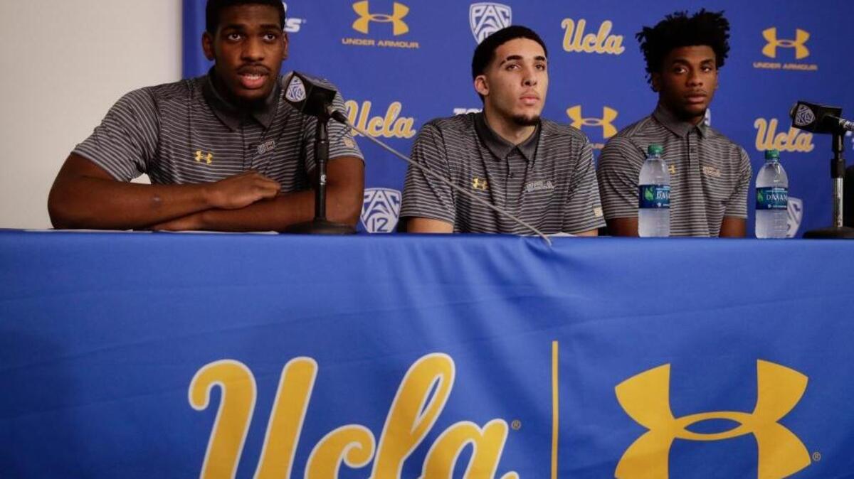UCLA basketball player Cody Riley, left, reads his statement as he is joined by teammates LiAngelo Ball, center, and Jalen Hill during a news conference Wednesday in Los Angeles. They were accused of shoplifting in China and have been suspended indefinitely.