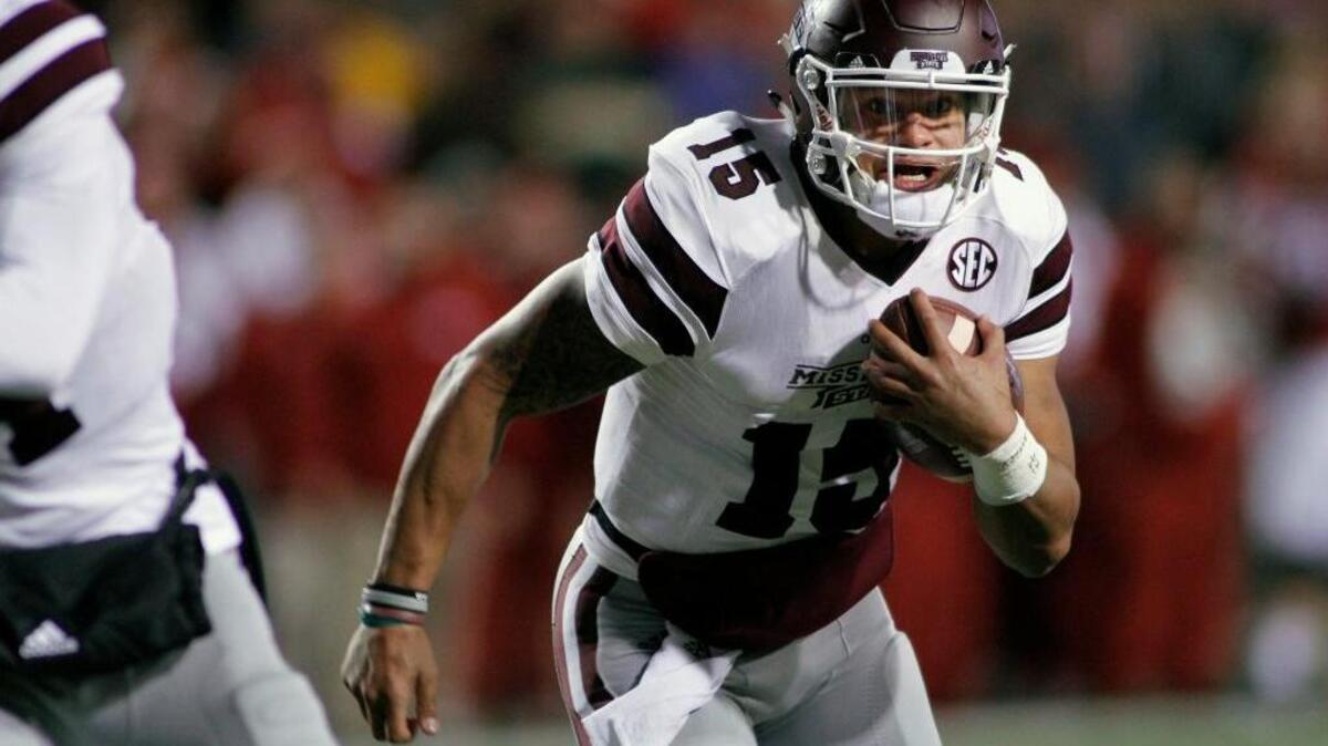 Mississippi State’s Dak Prescott (15) keep the ball and runs during an NCAA college football game against Arkansas, Saturday, Nov. 21, 2015 in Fayetteville, Ark.