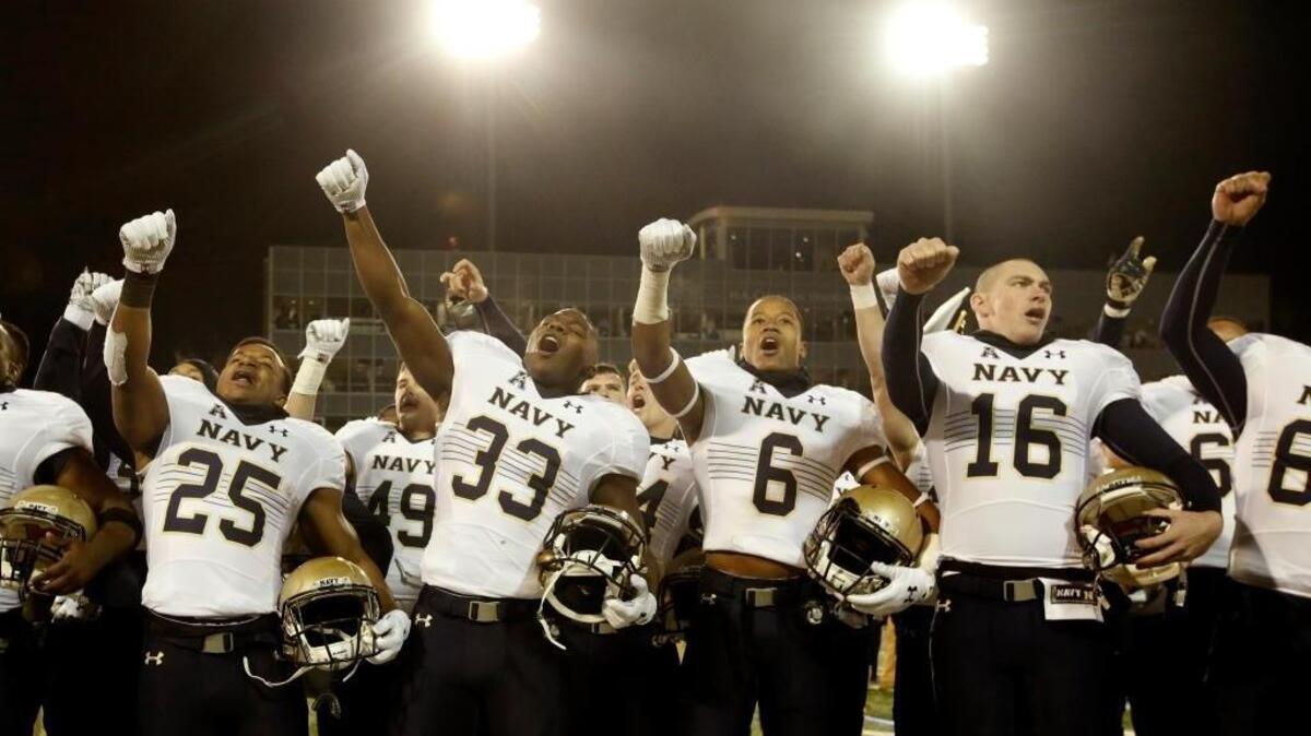 Navy players celebrate following their win over Tulsa in an NCAA college football game, Saturday, Nov. 21, 2015 in Tulsa, Okla. The Midshipmen meet 10-1 Houston on Friday, Nov. 27, 2015.