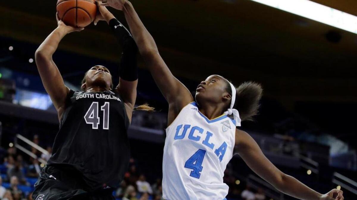 South Carolina center Alaina Coates, left, shoots over UCLA forward Ashley Hearn during the first half in Los Angeles, Sunday, Nov. 22, 2015.
