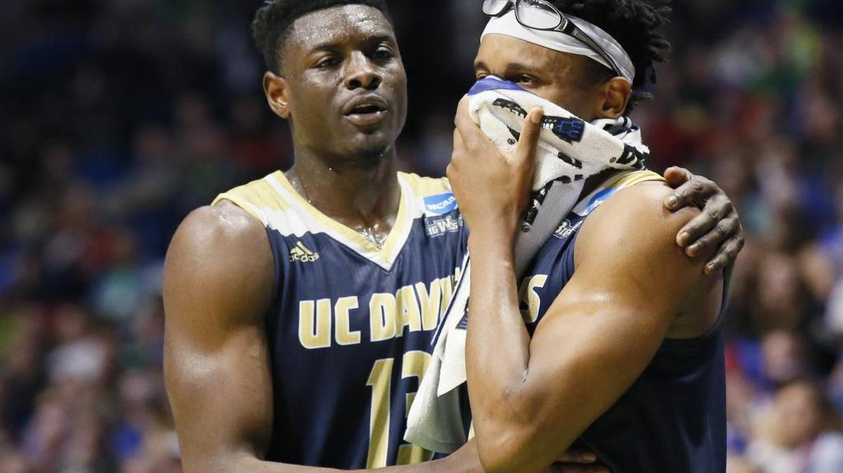 UC Davis forward J.T. Adenrele, left, consoles teammate Chima Moneke, right, late in the second half of a first-round game against Kansas in the men's NCAA college basketball tournament in Tulsa, Okla., on Friday. Kansas won 100-62.