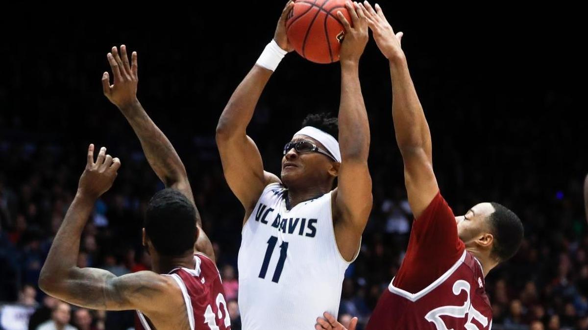 UC Davis’ Chima Moneke, center, shoots against North Carolina Central’s Pablo Rivas, left, and Kyle Benton during an NCAA Tournament First Four game Wednesday in Dayton, Ohio.
