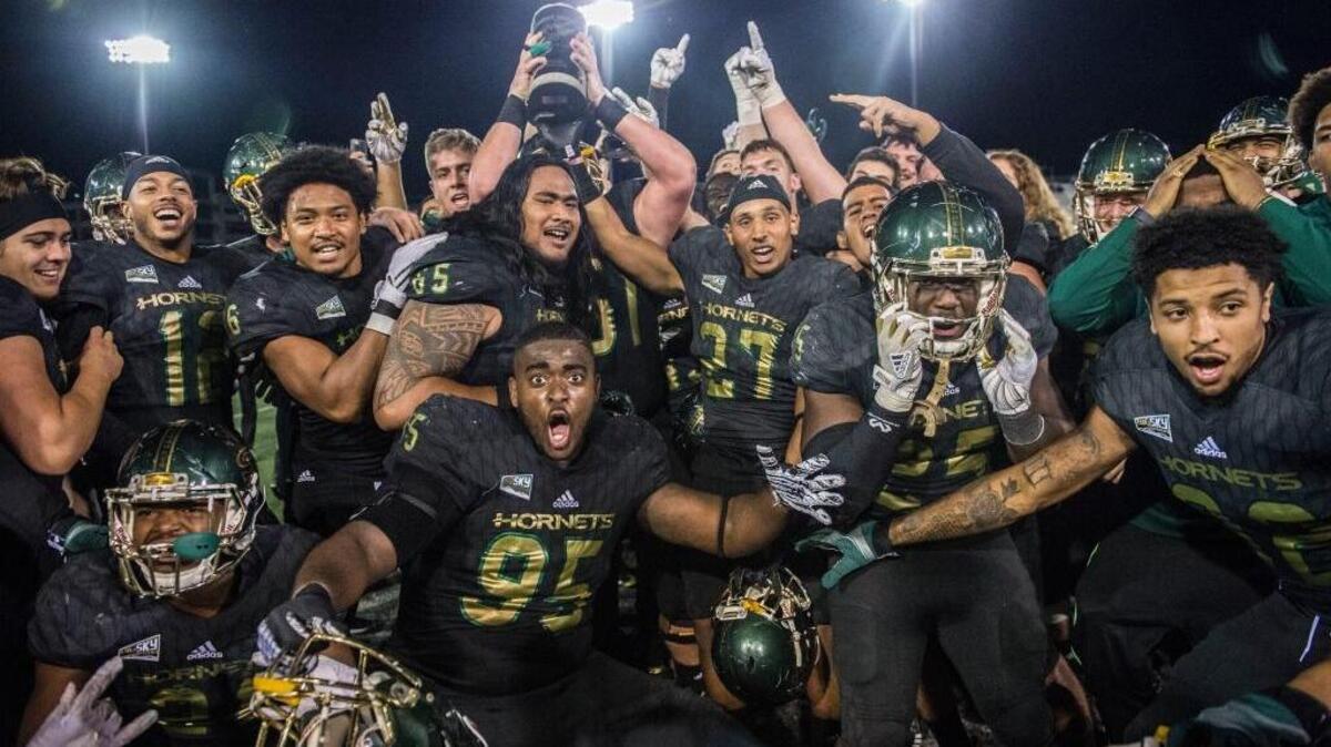 Sacramento State players celebrate their 52-47 victory over UC Davis in the Causeway Classic on Saturday at Hornet Stadium.