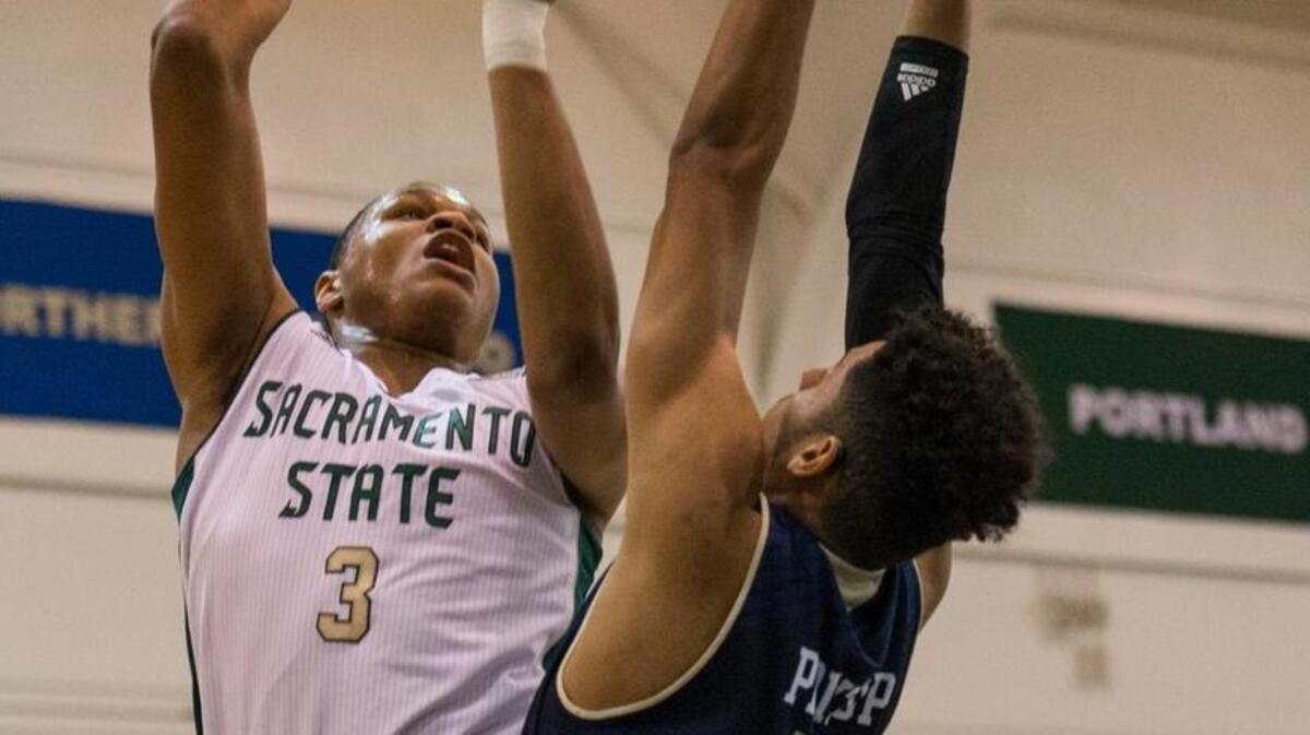 Sacramento State forward Justin Strings (3) rises up for a shot while being defended by UC Davis guard Rogers Printup (23) during the first half of the team’s game in Sacramento on Tuesday, Nov. 24.
