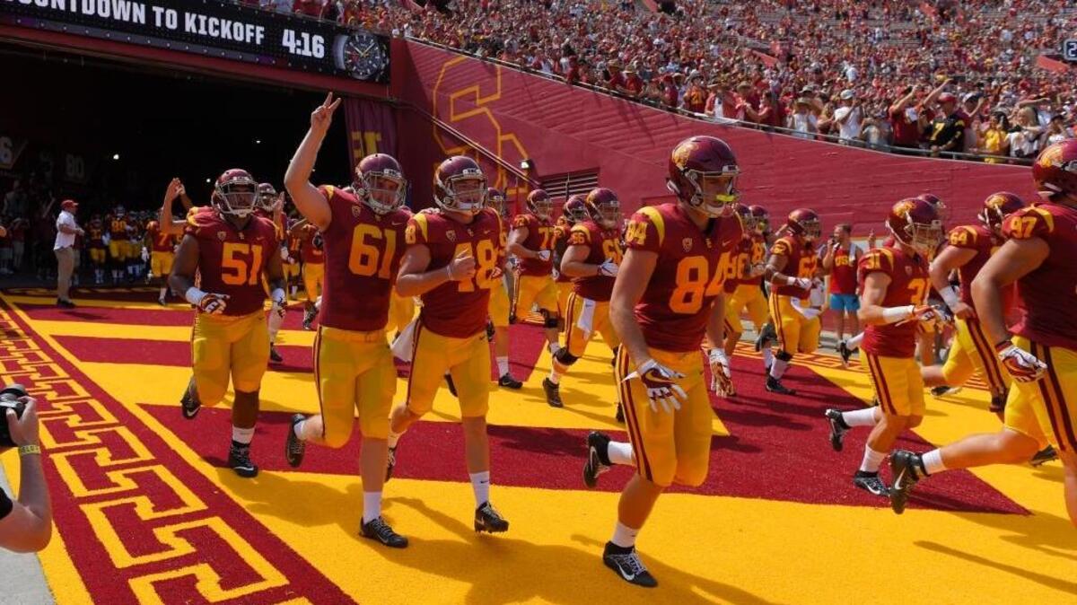 USC players run out to the field prior to an NCAA college football game against Western Michigan, Saturday, Sept. 2, 2017, in Los Angeles.
