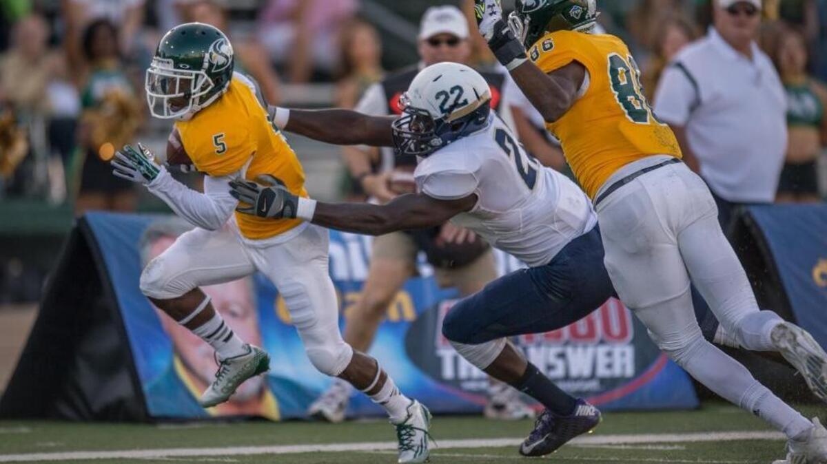 
Sacramento State wide receiver Isiah Hennie (5) evades a tackle from Eastern Oregon defensive back Kalliy Ceesay (22) and runs to the end zone for a touchdown on Sept. 5 in Sacramento.
