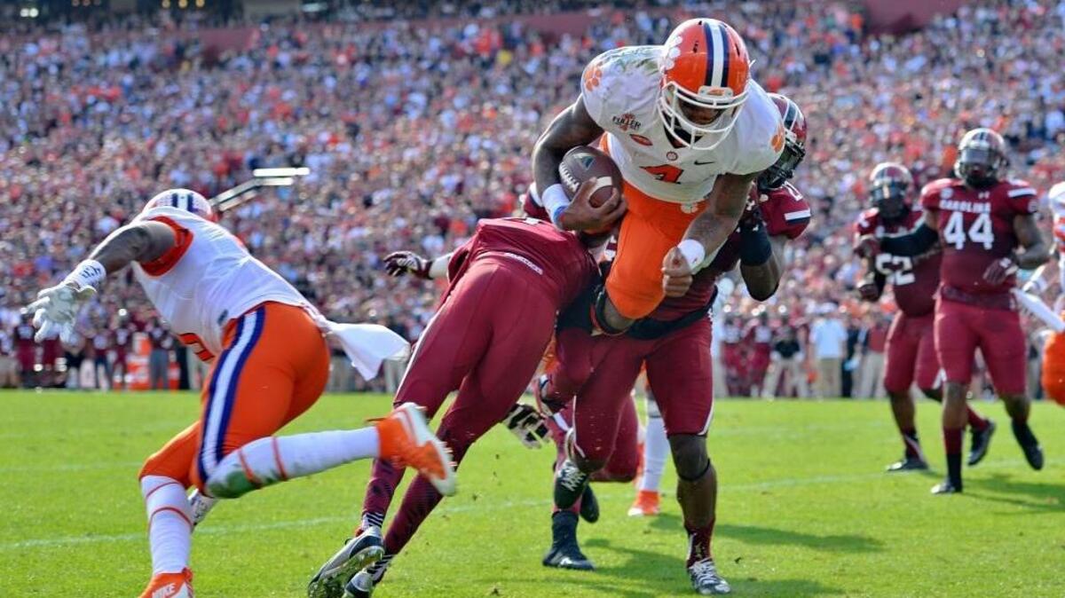 Clemson quarterback Deshaun Watson (4) dives into the endzone for a 5-yard touchdown run during the first half of an NCAA college football game against South Carolina, Saturday, Nov. 28, 2015, in Columbia, S.C.