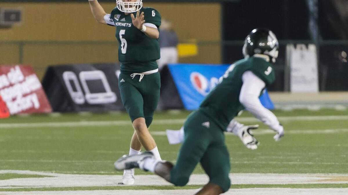 Sacramento State Hornets quarterback Nate Ketteringham (6), passes the ball to Sacramento State Hornets defensive back Malcolm Thomas (9), during the second quarter as the Sacramento State Hornets host the Idaho State Bengals Saturday October 24, 2015.