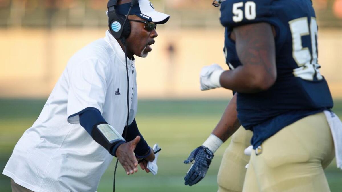 UC Davis coach Ron Gould greets his players at the sideline during a game against Cal Poly in Davis, on Saturday, Nov. 14, 2015. Cal Poly won 55-38.
